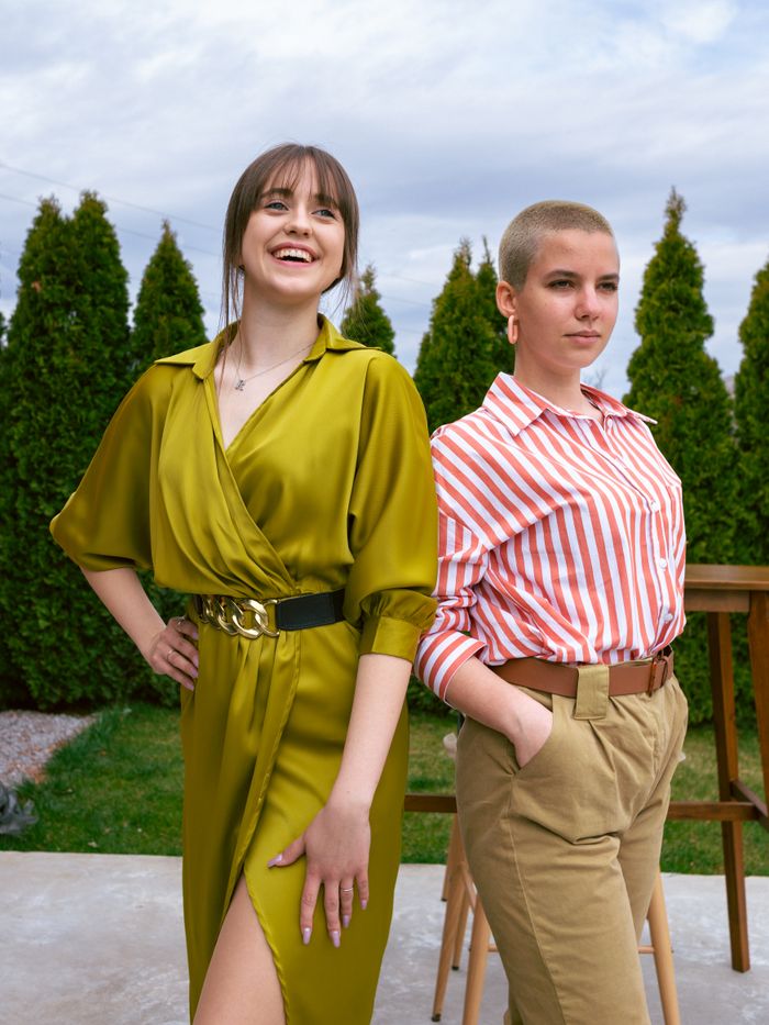 Services Two women enjoying a day outdoors in fashionable clothing, exuding confidence and joy.